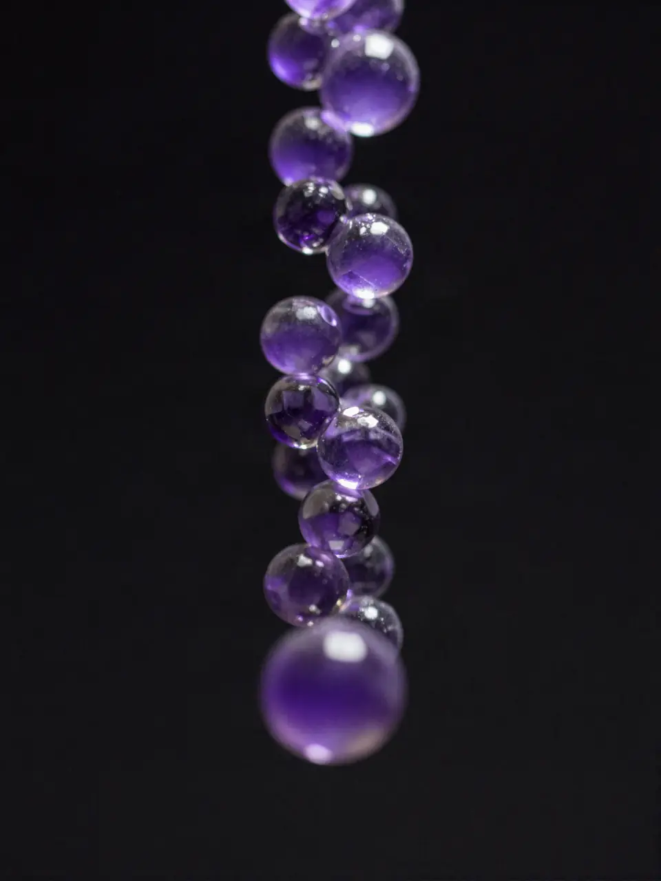 A hanging string of violet glass beads